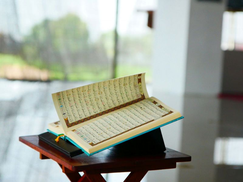 Sheet music resting on a closed laptop