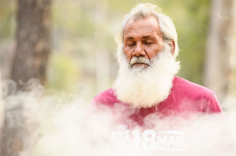 Uncle Milton Lawton, eyes closed with rising smoke